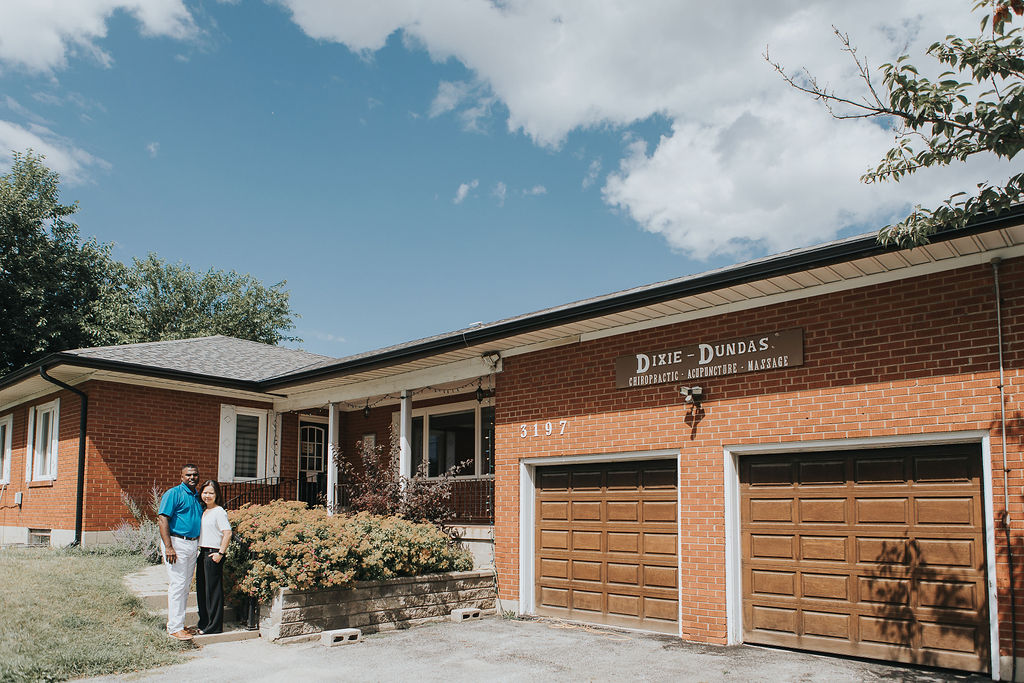 Dr. Thao Bui and Dr. Andre Rodrigues standing in front of Acupuncture Heals clinic in Mississauga