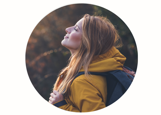 Relaxed person smiling outdoors after completing a course of care